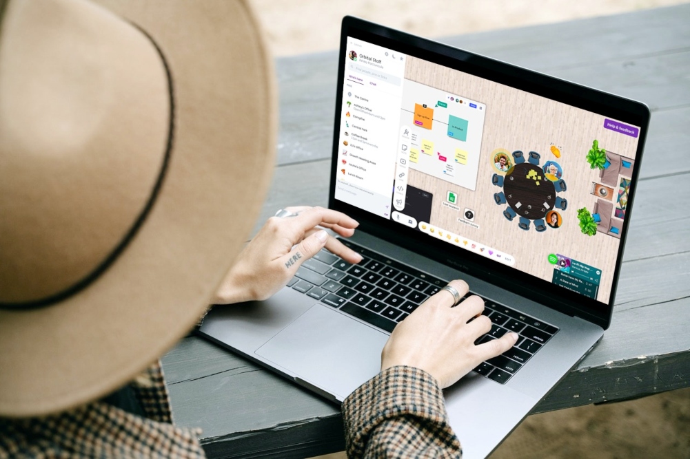 Woman using orbital remote work tool on computer.