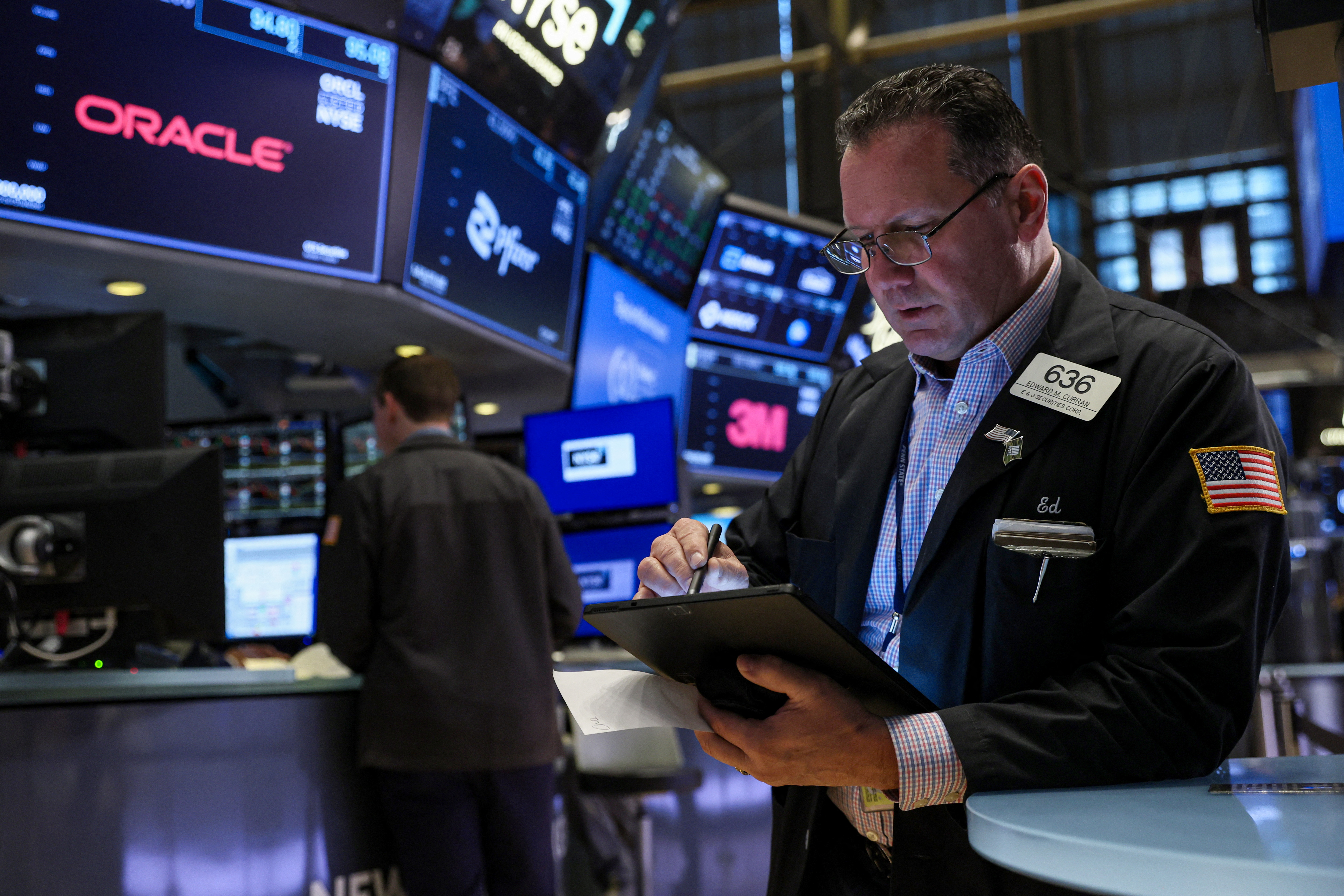 Traders work on the floor of the NYSE in New York