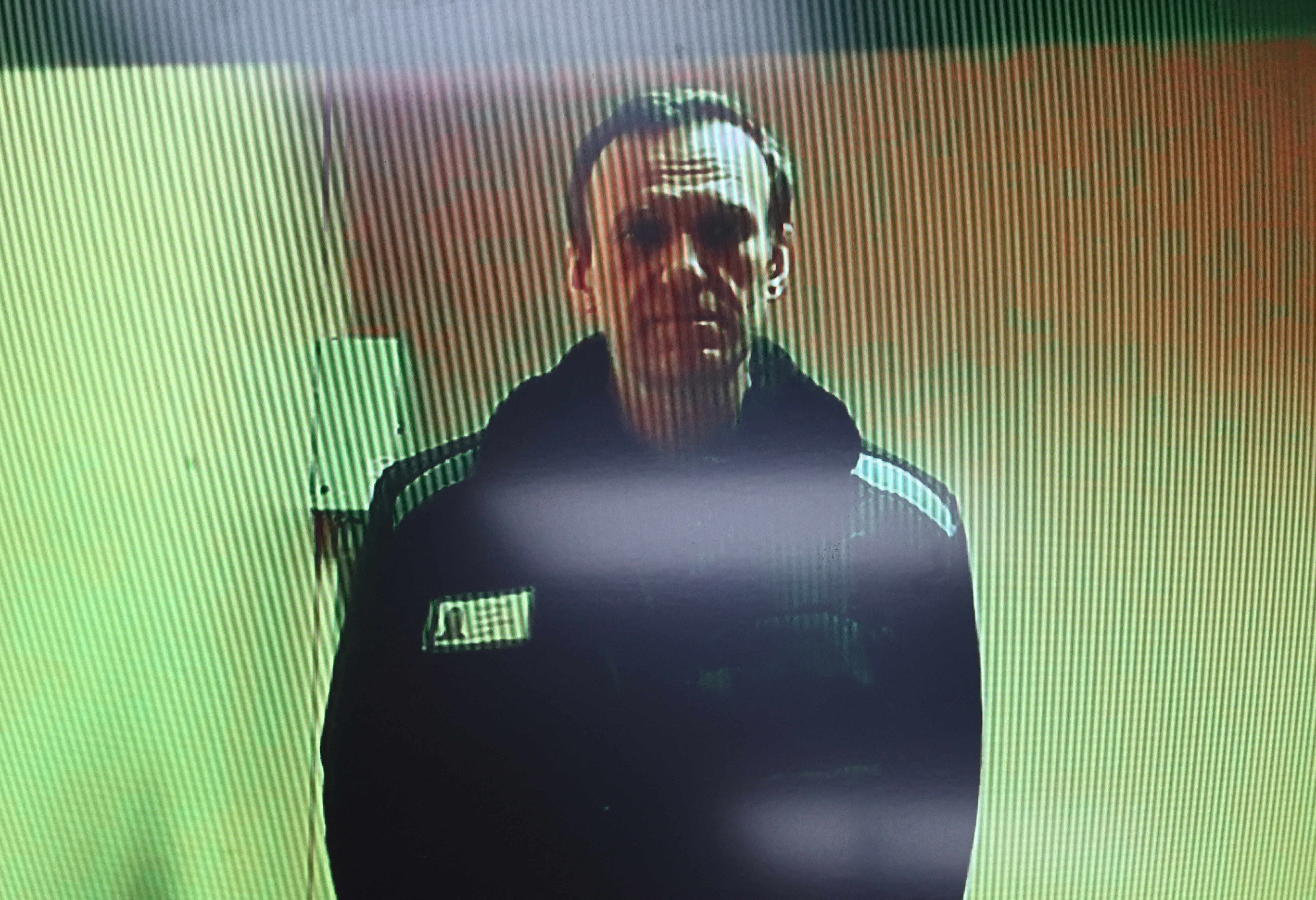 Russian opposition leader Alexei Navalny is seen on a screen via video link during a court hearing in Moscow
