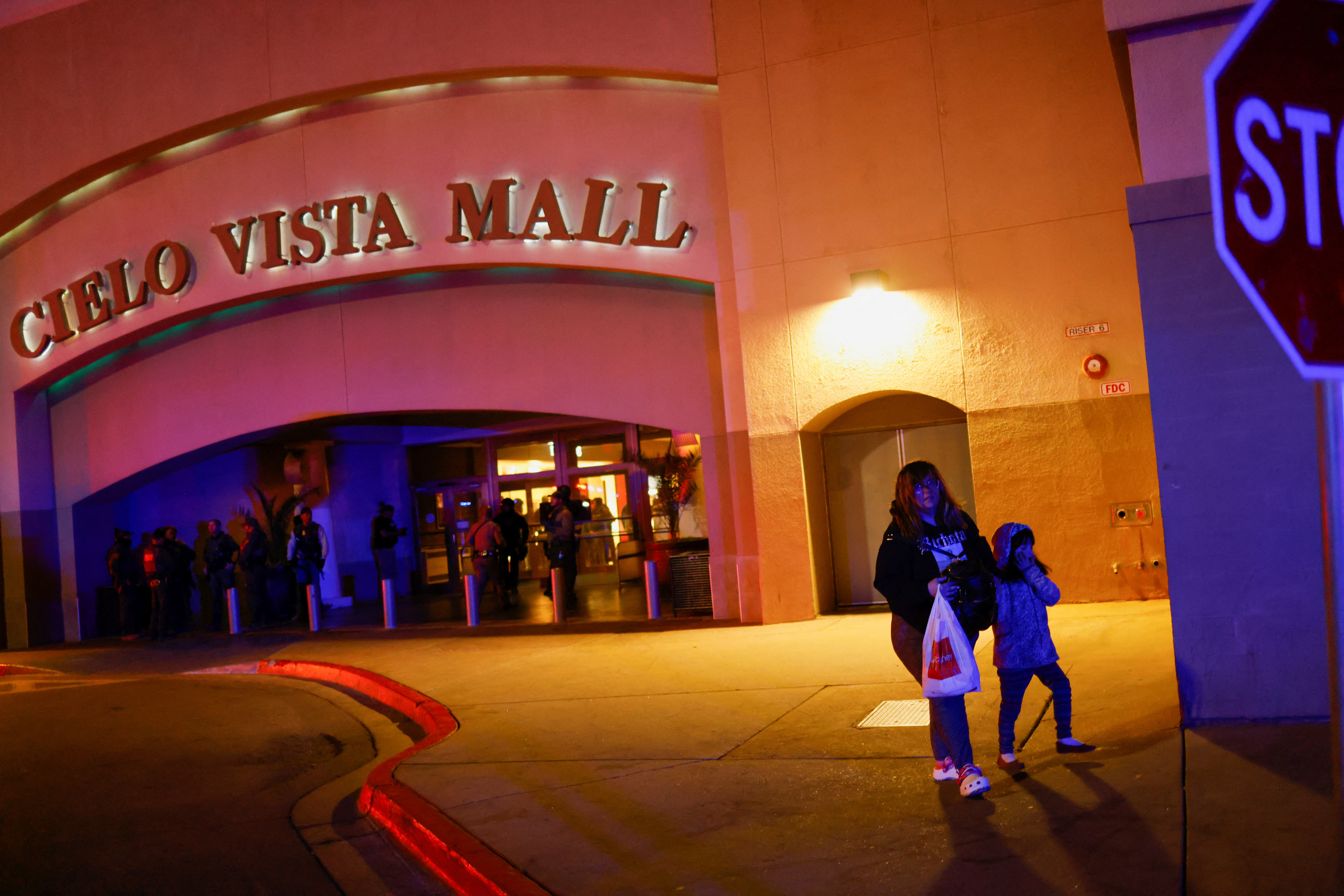 Shoppers leave as law enforcement members respond to a shooting at the Cielo Vista Mall in El Paso